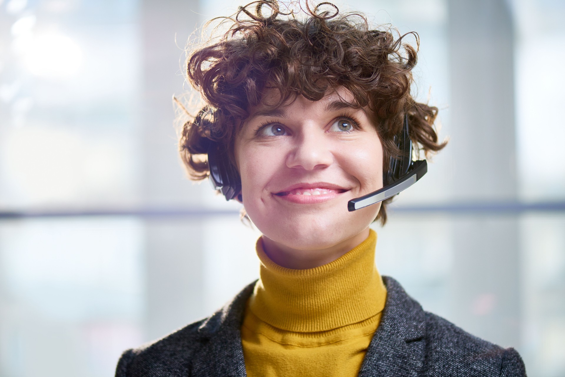 Happy worker of call center in sunlight